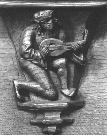 Koorbanken, detail: misericorde met musicus die op zijn luit speelt