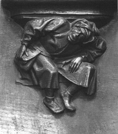 Koorbanken, detail: misericorde met ineengekropen figuur