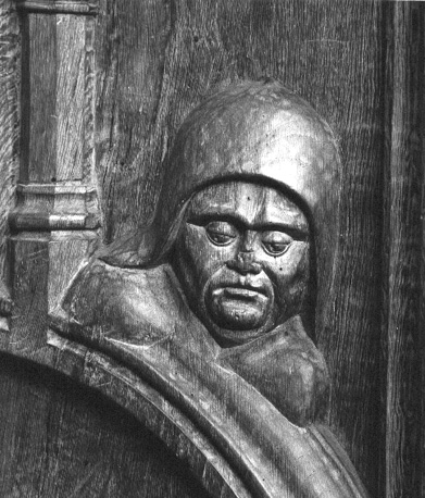 Koorbanken, detail: mannenkop op een zijleuning