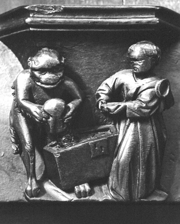 Koorbanken, detail: misericorde met monnik en duivel die schatkist vult (gierigheid; avaritia)