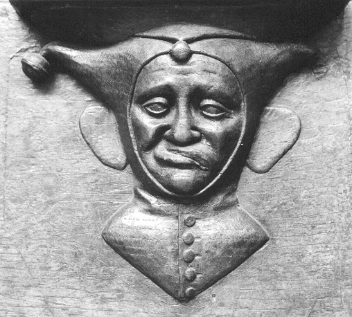 Koorbanken, detail: misericorde met het hoofd van een nar