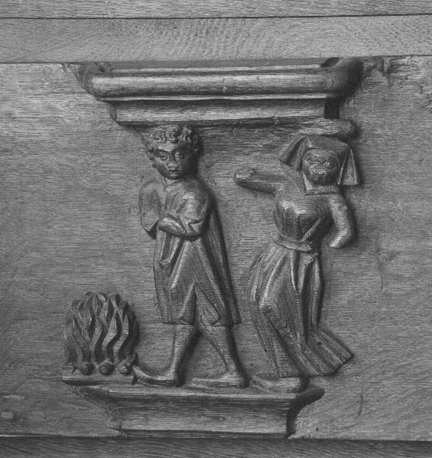 Koorbanken, detail: misericorde met spreekwoord "Iemand het vuur na aan de schenen leggen"