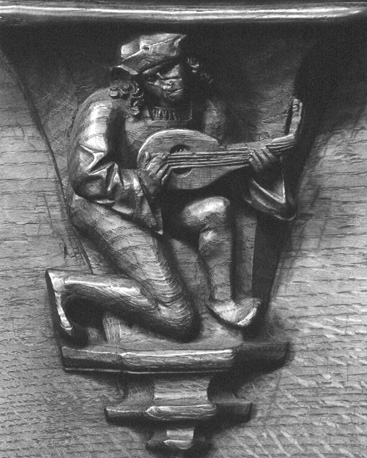 Koorbanken, detail: misericorde met musicus die op zijn luit speelt