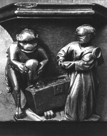 Koorbanken, detail: misericorde met monnik en duivel die schatkist vult (gierigheid; avaritia)