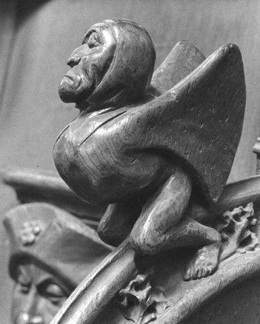 Koorbanken, detail: knop van een menselijk wezen met vleugels