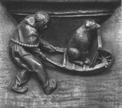 Koorbanken, detail: misericorde met man die kruiwagen met hond voortduwt (omgekeerde wereld)