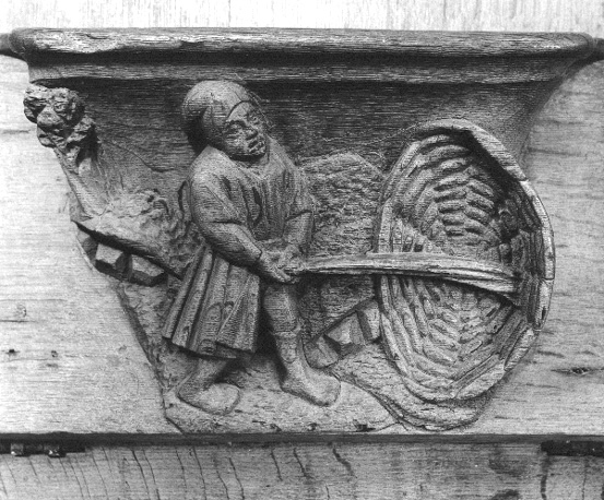 Koorbanken, detail: misericorde met gezegde "Petite Pluie Abat Grand Vent"