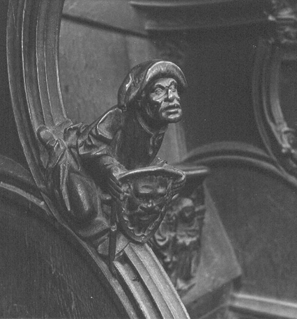 Koorbanken, detail: knop met zittende man met een schild