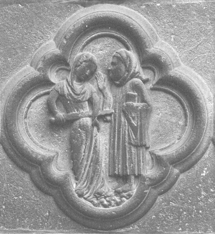 Westfacade, middenportaal;   vierpas met een afbeelding van de gramschap / woede