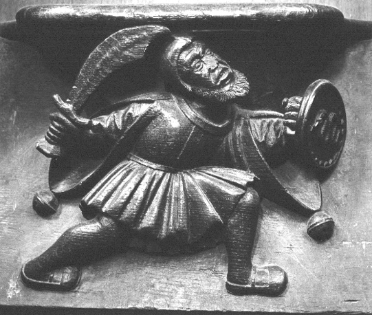 Koorgestoelte, detail: misericorde: Man met zwaard en schild