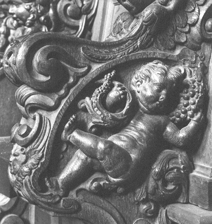 Koorgestoelte, detail: cupido / putto