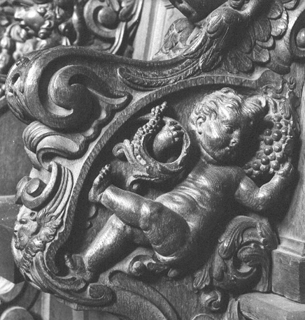 Koorgestoelte, detail: cupido / putto