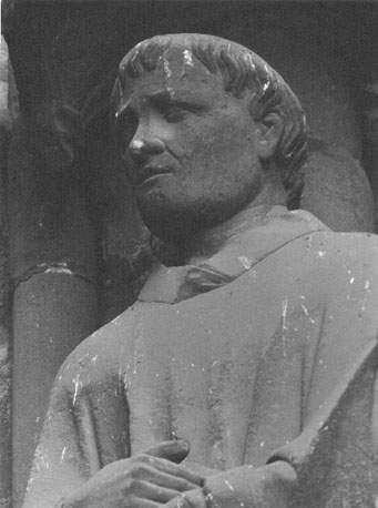 Westfacade, linker portaal (van Sint Firmin), tweede beeld van rechts; detail: hoofd van heilige