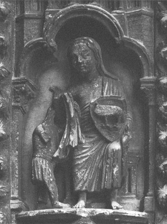 Zuidtransept, linker portaal / portiek, rechter pijler, westzijde: reliëf, voorstelling van Liefdadigheid