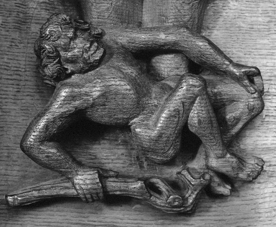 Koorbanken; misericorde met grotesque figuur (naakte man met stok)