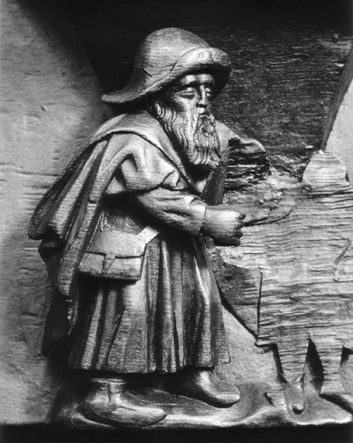 Koorbanken, detail: misericorde met pelgrim gekleed in lange tuniek met een tas en op de rand van de hoed een pelgrimsteken